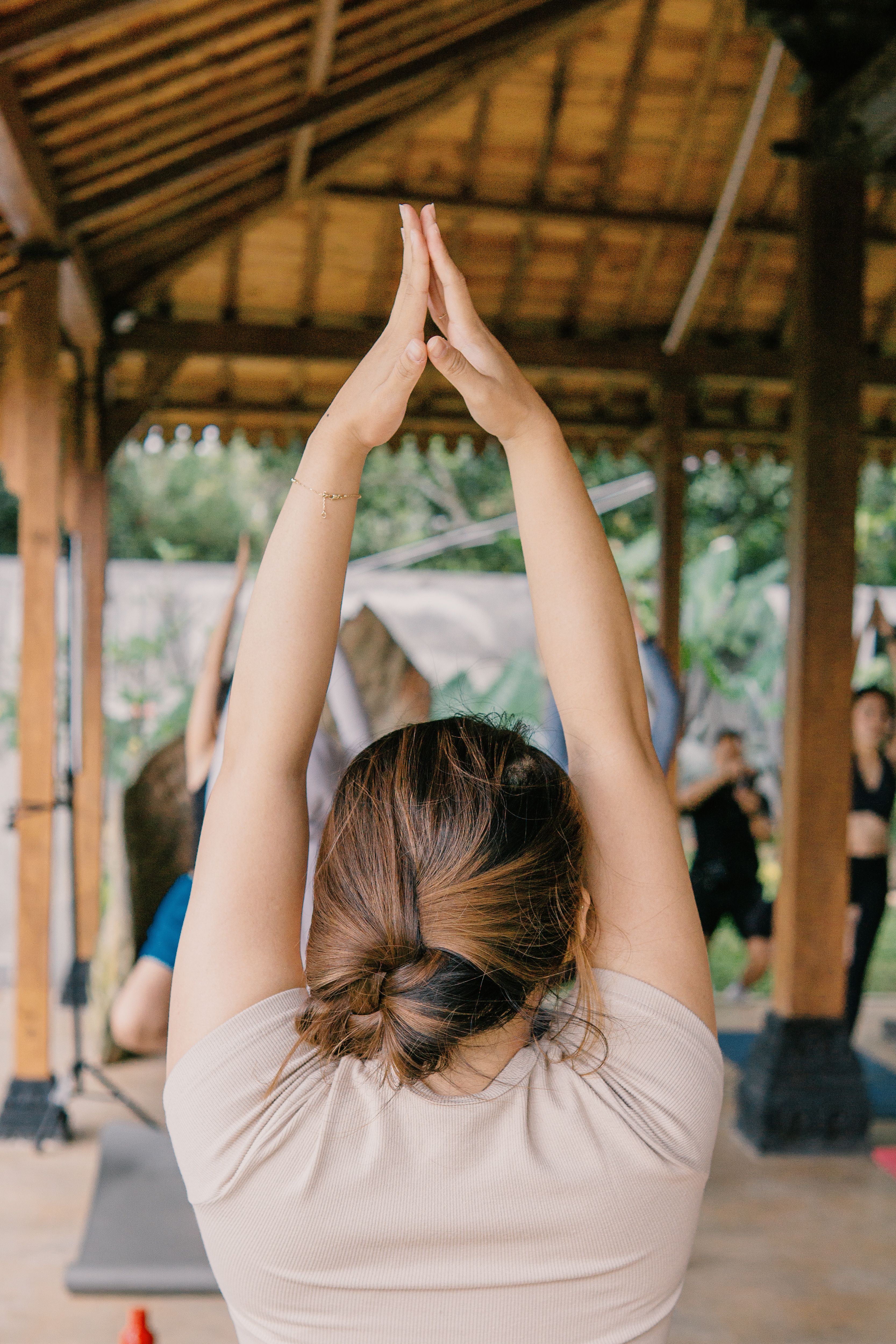 Outdoor yoga class in a traditional open-air pavilion