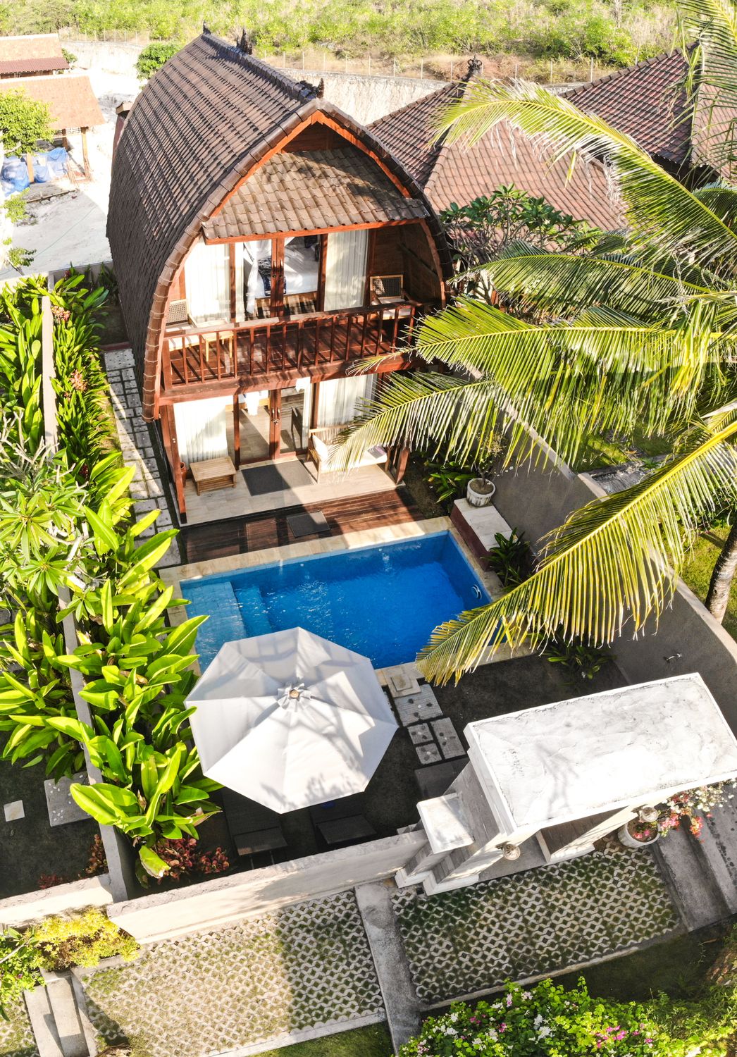 Tropical villa with swimming pool surrounded by lush greenery in Bali