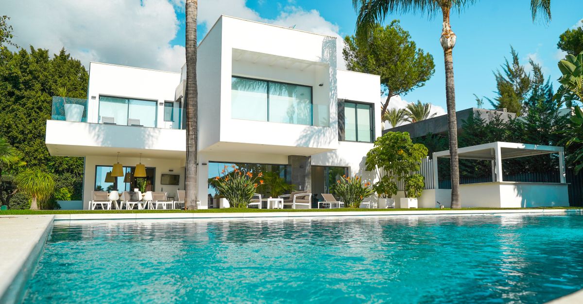 Modern luxury villa with swimming pool surrounded by tropical garden