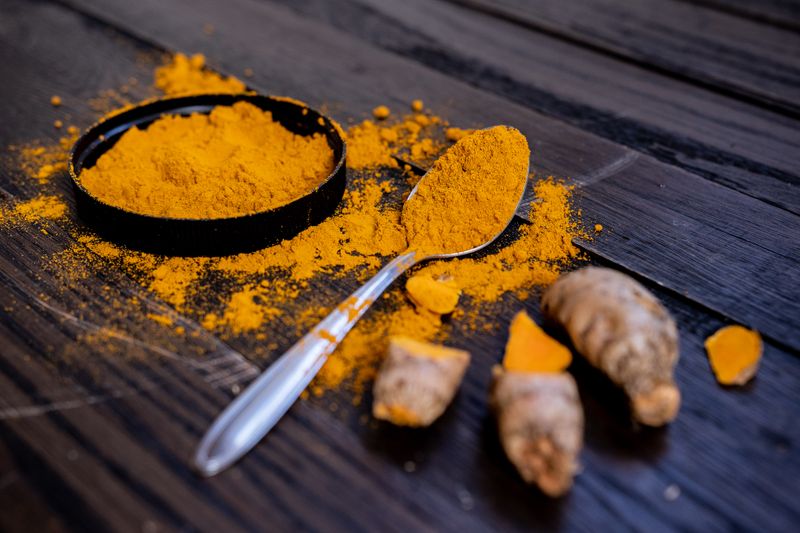 Close-up of vibrant turmeric powder, a key ingredient in Balinese beauty treatments
