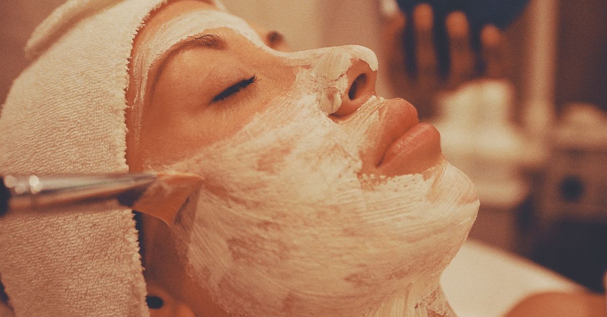 A woman receiving a relaxing facial mask treatment at a Bali spa