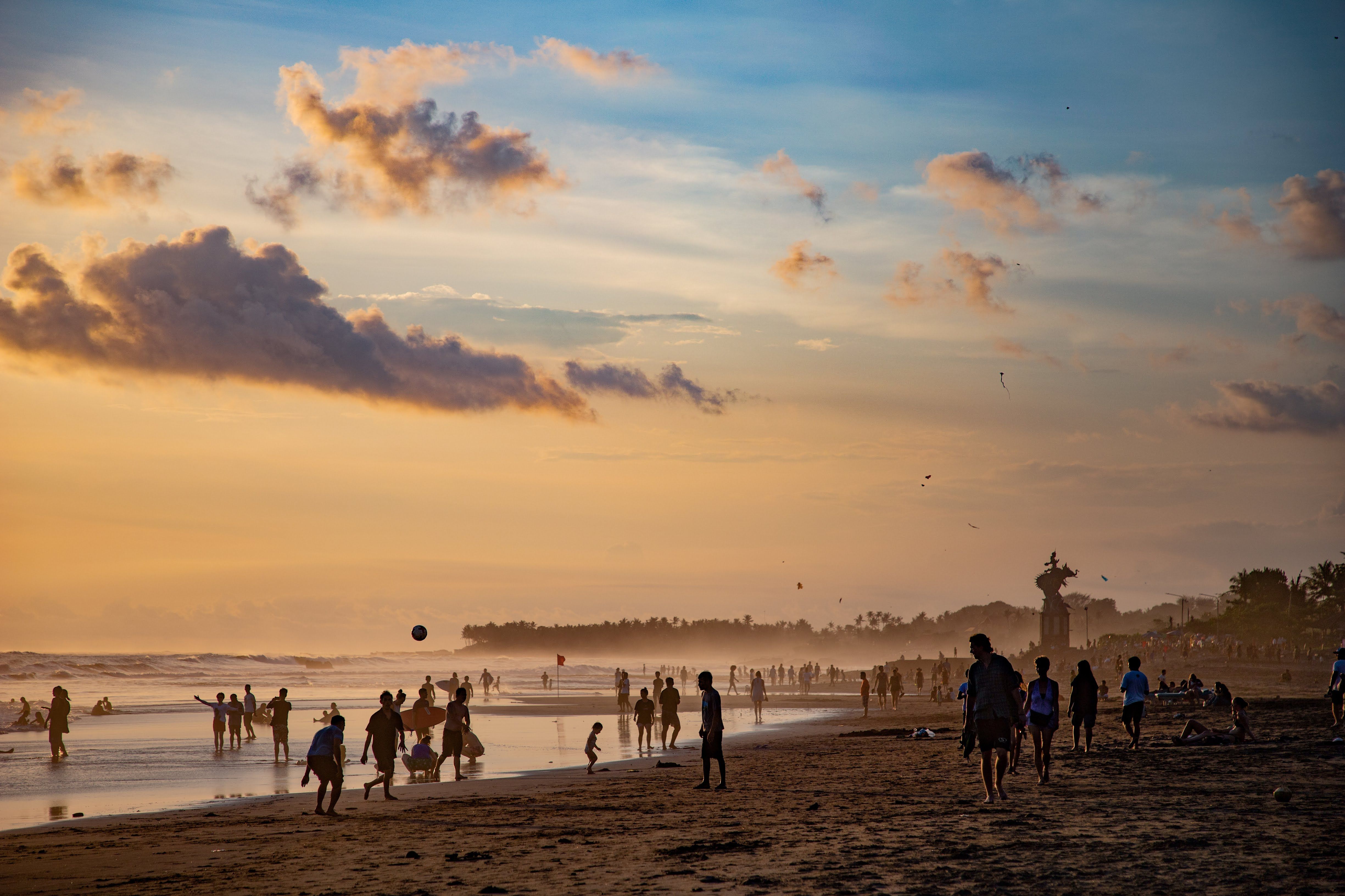 People enjoying a vibrant sunset at Canggu Beach, Bali