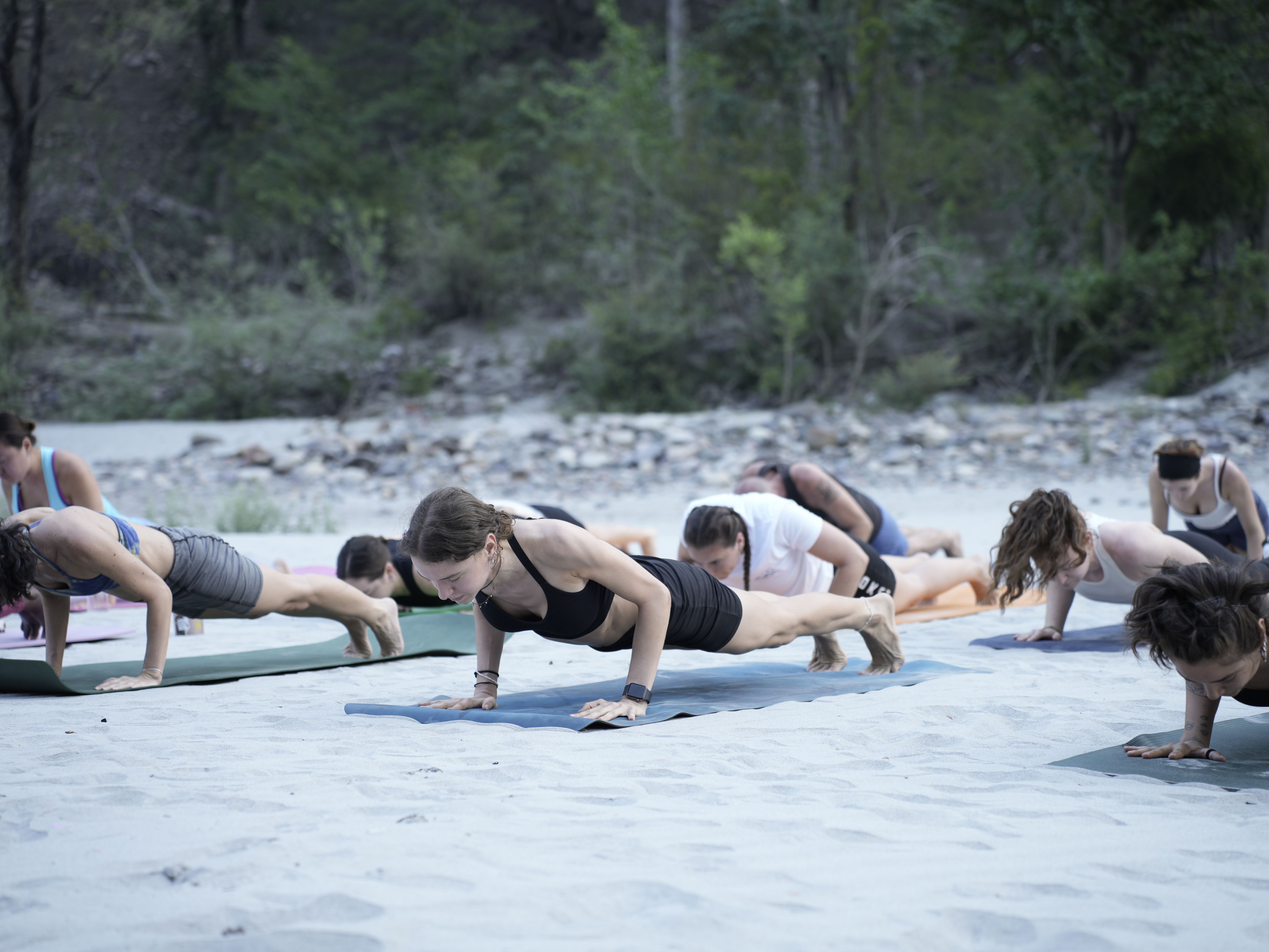 A group yoga class practising outdoors in a lush tropical Bali setting