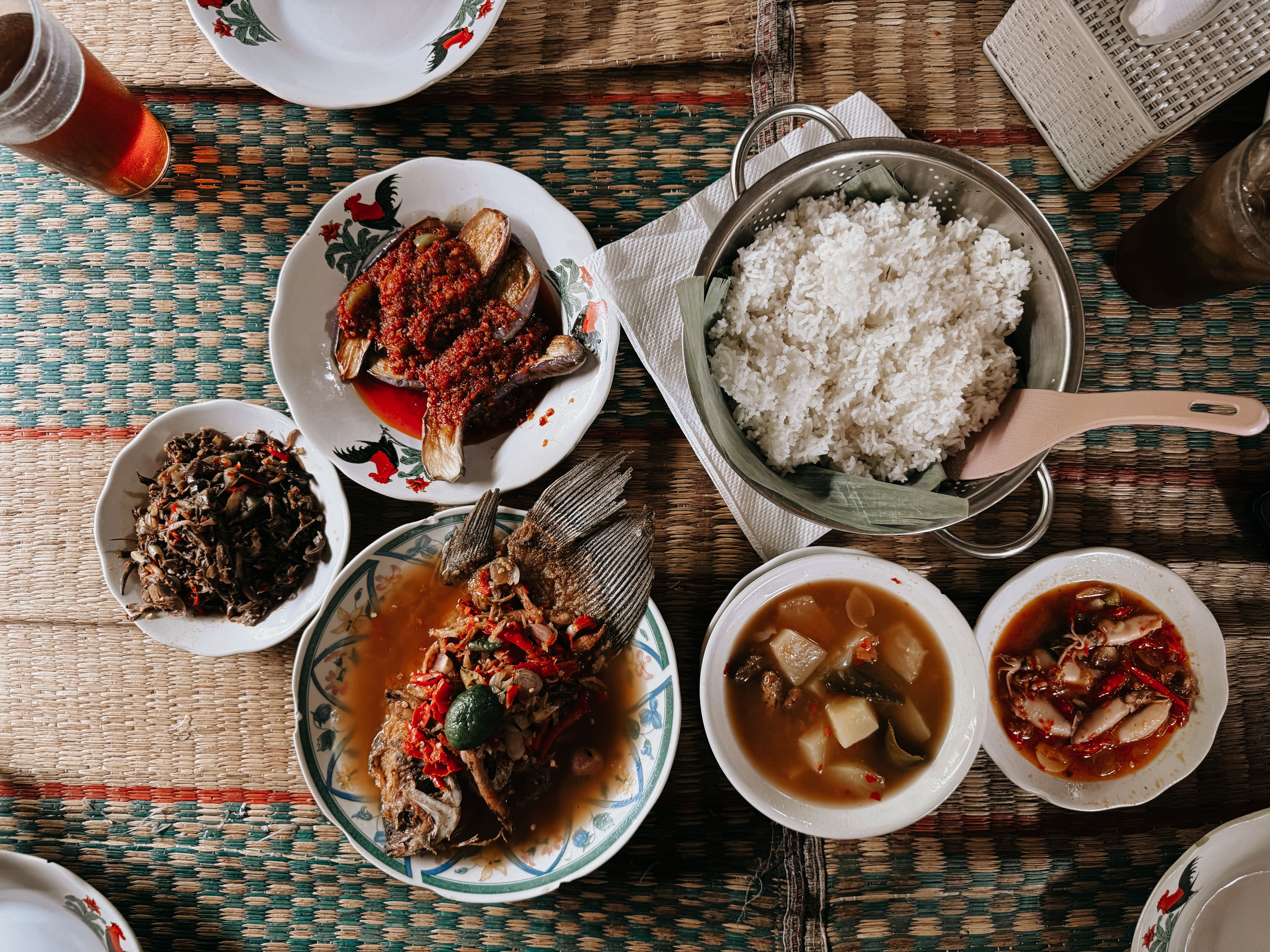 A quiet Balinese warung with simple wooden tables and chairs, a place where locals gather for lunch