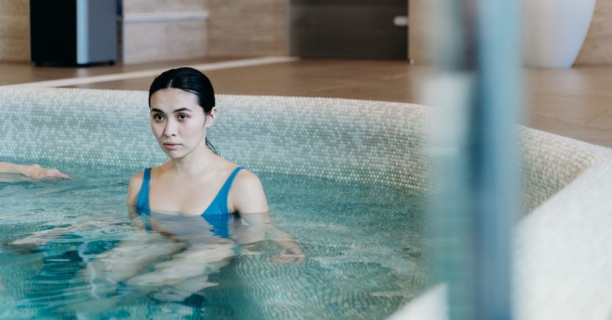Calm woman enjoying leisure time in an indoor swimming pool. Perfect for lifestyle and wellness themes.