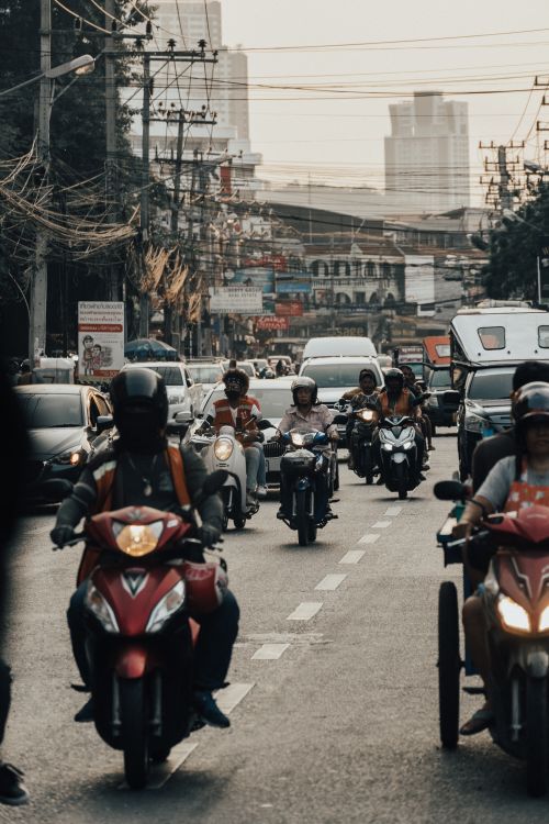 Motorcycles and cars on a busy Bali road, where scenes like this have become the norm in Canggu during peak hours