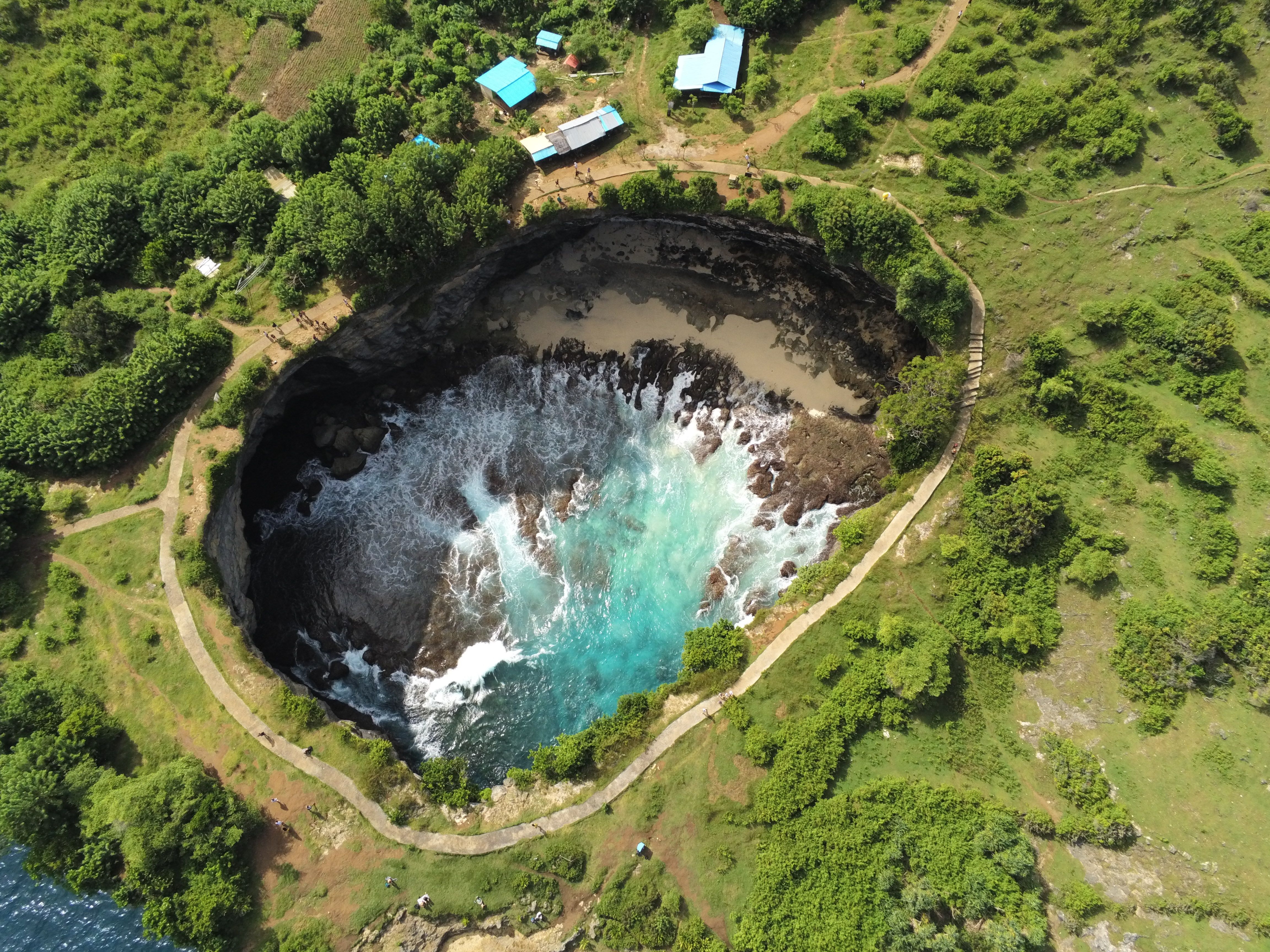 Dramatic coastal cliff viewpoint on Nusa Penida with turquoise water below