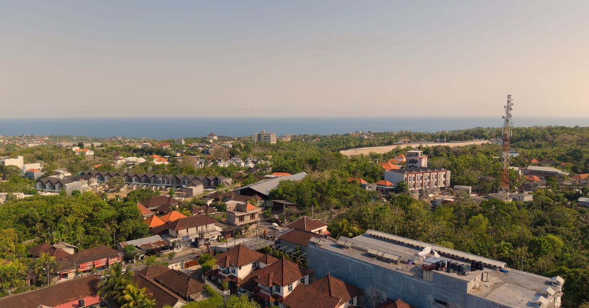 Aerial view of Bali coastal landscape with turquoise water and lush greenery