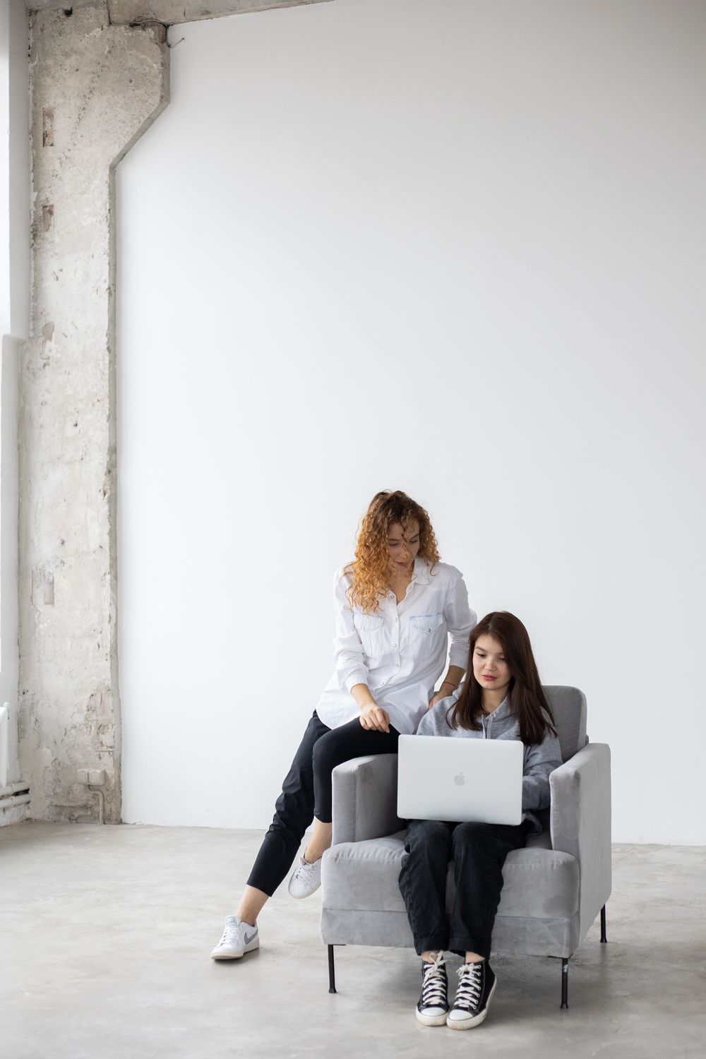 Focused women working on laptops in a modern coworking space