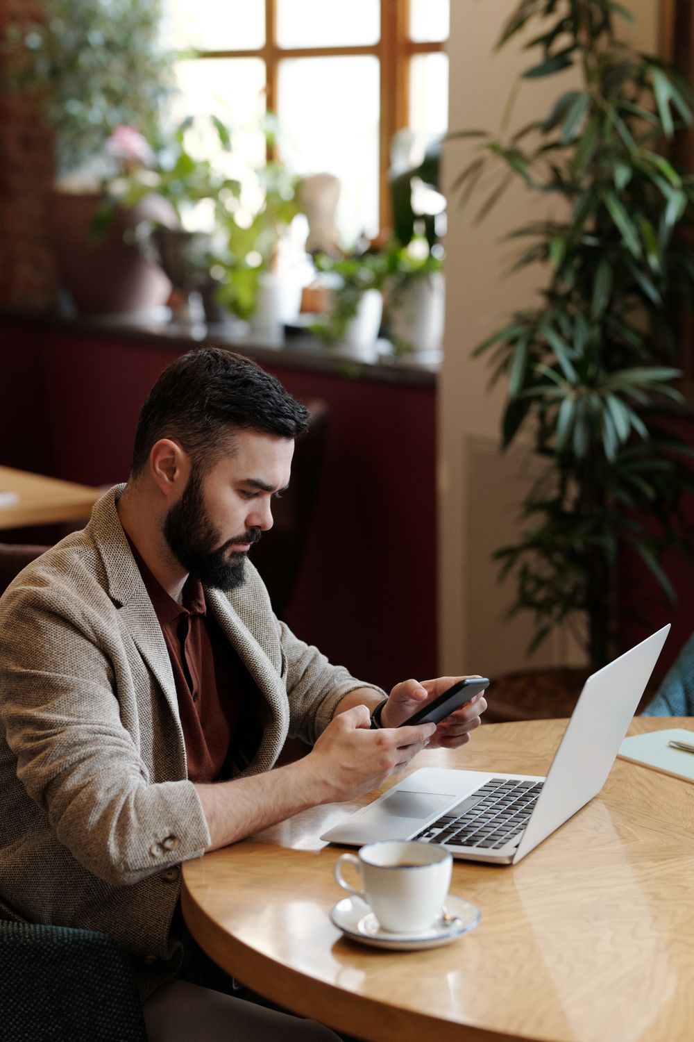 A man reviewing documents on a smartphone in a professional setting