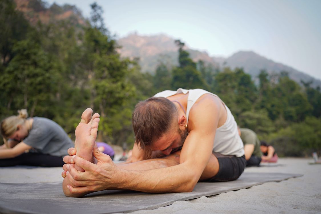 Group practising yoga outdoors in a lush garden setting in Bali